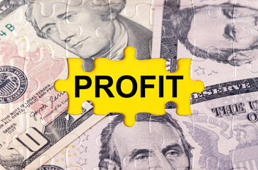 Fototapeta premium Puzzle with the image of dollars in the center of the inscription -PROFIT