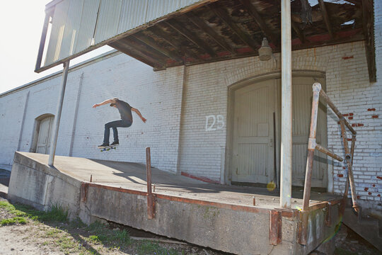 Skateboarding an impromptu ramp at an abandoned factory