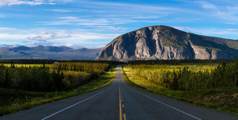 Scenic Route, Alaska Hwy, during a sunny and cloudy day. Mountains in Background. Near Haines...