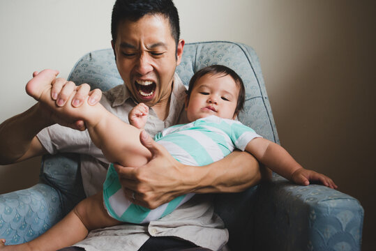 Dad playing with baby
