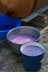 Grape juice close up during the autumn harvest. Traditional old technique of wine making. Filtering grape must.