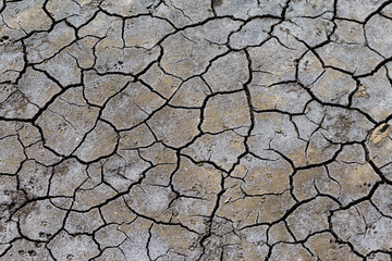Part of a huge area of dried land suffering from drought in cracks..