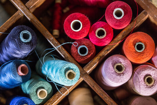Colorful rolls of yarn in wooden box