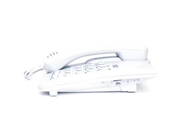 White push-button old landline telephone on isolated white background close up