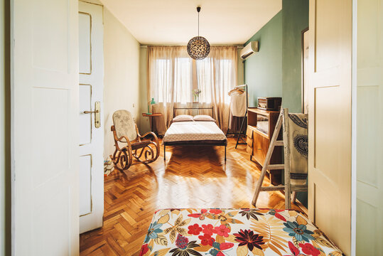 Cosy bedroom by sunset in eclectic interior