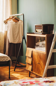 Detail shot of old cabinet and shtender with hangers and clothes on it