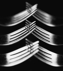 Composition made of forks on the black background.