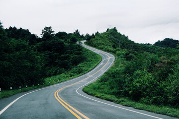 Fototapeta premium The highway through the mountain forest