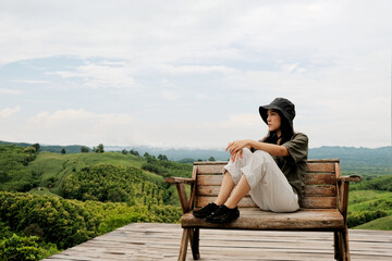 Asian female tourists travel in beautiful forests and mountains.