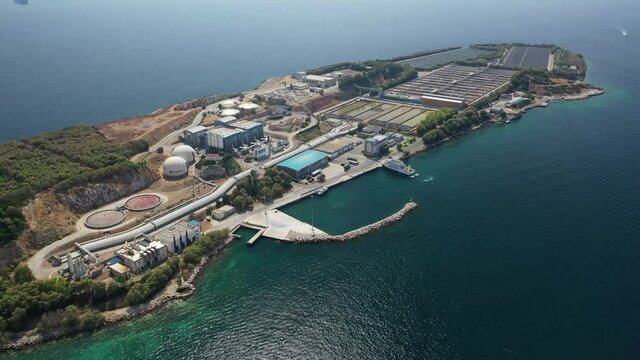 Aerial drone video of small island of Psitaleia a latest technology industrial sewage plant near port of Piraeus, Attica, Greece