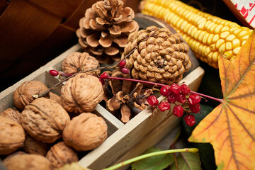 autumn still life in rustic style as a background - leaves, vegetables and fruits, nuts and other natural food ingredients on wooden boards