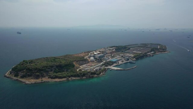 Aerial drone video of small island of Psitaleia a latest technology industrial sewage plant near port of Piraeus, Attica, Greece
