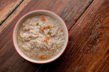 Breakfast Pork Congee on white bowl