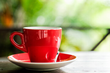 Hot coffee in Red coffee cup on wood table