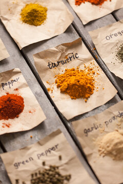 Colourful Spices on Pieces of Paper