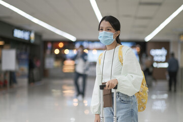 Asian travelers girl with medical face mask to protection the Covid-19 in airport