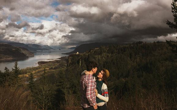 laughing in front of river landscape