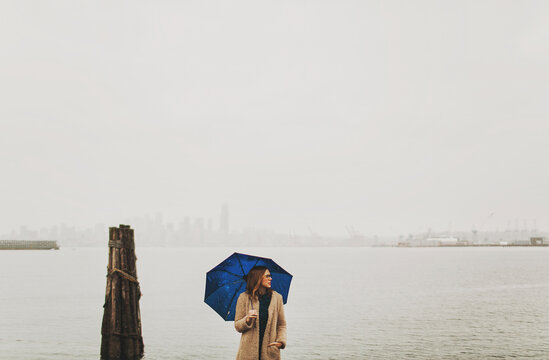 girl in fog with blue umbrella