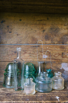 Collection of vintage glass bottles and insulators - vertical
