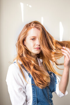 A young redhead girl in denim