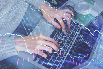 Double exposure of woman hands typing on computer and forex chart hologram drawing. Stock market invest concept.