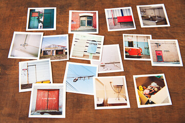 wooden tabletop with a collection of small medium format prints