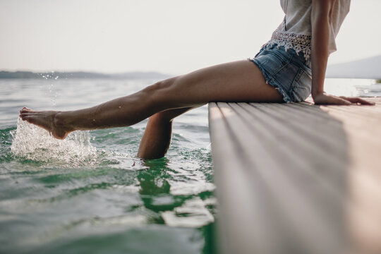 Woman dangling her legs in the water