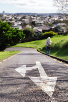 Woman walking on a sloping road