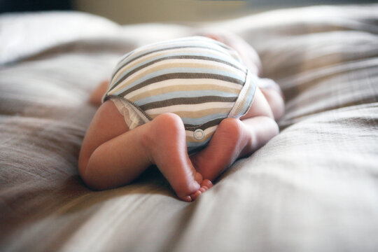 Rear View of Baby Wearing Striped Shirt Sleeping