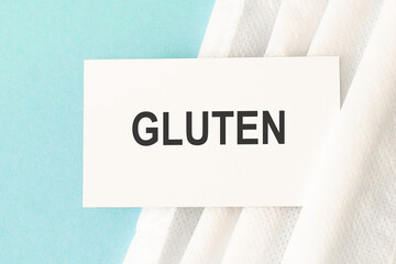 Word gluten with medical mask on a blue background. Medicine concept