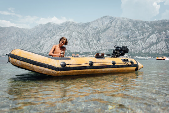 Young boy preparing for a ride in the rubber boat