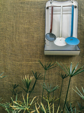 Vintage enamelware ladle rack and umbrella plant.