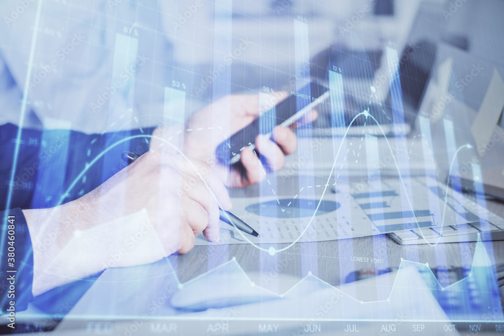Poster double exposure of man's hands holding and using a digital device and forex graph drawing. financial