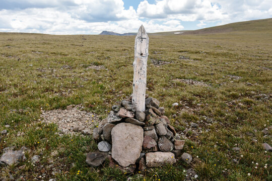 Trail marker on mountain path with missing sign