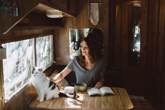 Woman reading and eating breakfast