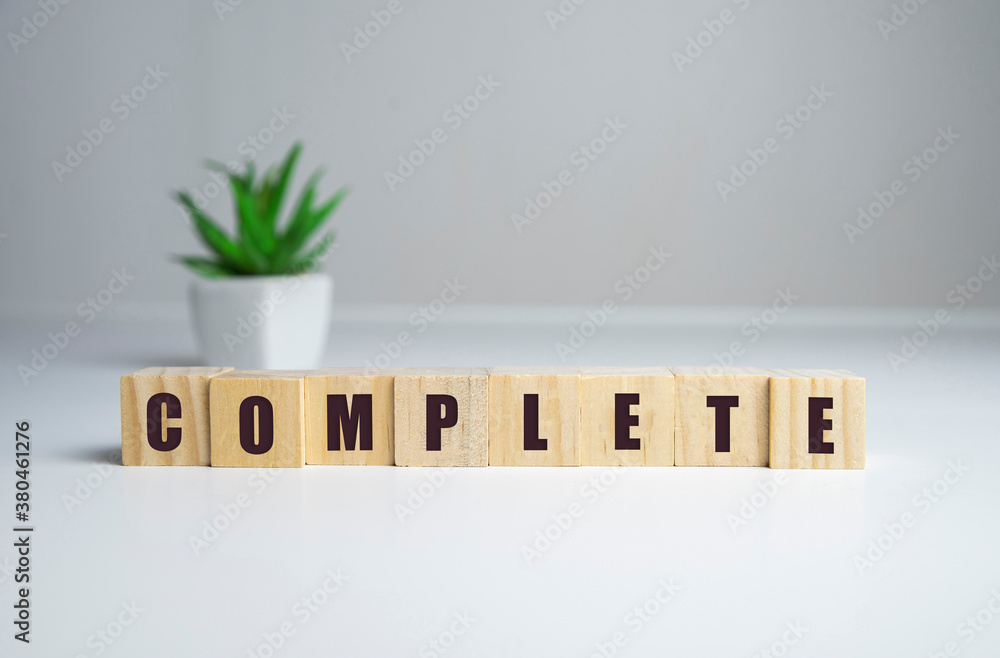 Fototapete dice the word complete . text dice cube concept letter dices alphabet on wooden background. block of