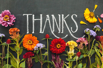 chalkboard ""Thanks"" surrounded by flowers