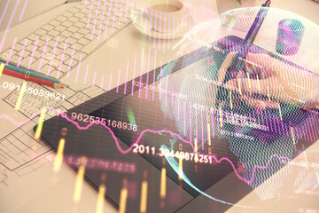 Double exposure of financial graph sketch hologram and woman holding and using a mobile device. Stock exchange concept.