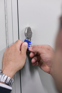 Male Hands Opening Padlock