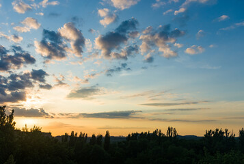 Fototapeta premium Landscape with dramatic light - beautiful golden sunset with saturated sky and clouds.