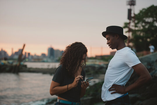 Woman putting her number in guy's phone