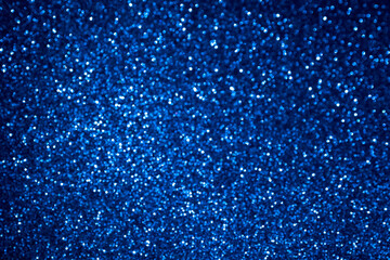 Abstract Blue bokeh. defocused glitter blur background. central light.
