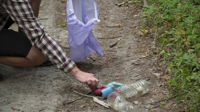 Man ride bicycle through forest, collecting trash. Trendy sports programs plogging that help preserve environment. Pollution. Ecological problem. Plastic ban awareness, national cleaning day concept.