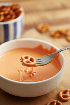 Preparing pumpkin shaped pretzels