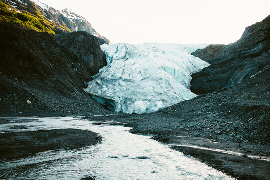 An Icy White Glacier Begets A Clear Cool Stream