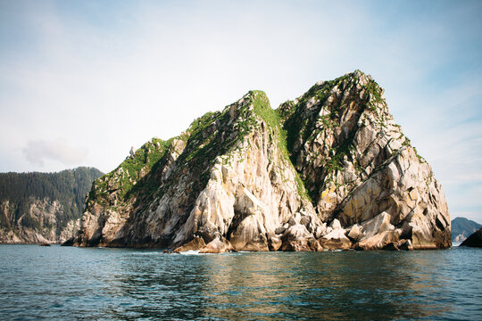 A Rocky Island Jutts Out Of The Ocean Water In Resurrection Bay
