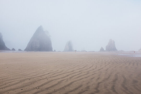 waves in sand on beach with beautiful rock formations west coast usa
