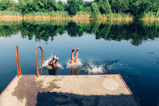 Three Men Diving in the Lake Head First