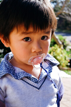 A child sucking on a pacifier