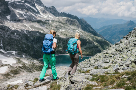two female hiking friends trekking in the mountains
